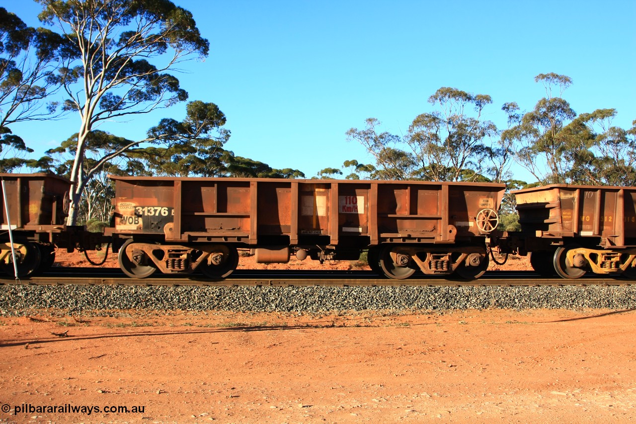 100731 03117
WOB type iron ore waggon WOB 31376 is leader of a batch of twenty five built by Comeng WA between 1974 and 1975 and converted from Mt Newman high sided waggons by WAGR Midland Workshops with a capacity of 67 tons with fleet number 301 for Koolyanobbing iron ore operations., empty train arriving at Binduli Triangle, 31st July 2010.
Keywords: WOB-type;WOB31376;Comeng-WA;Mt-Newman-Mining;