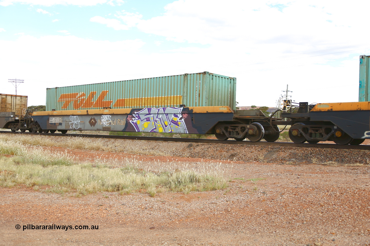 210407 9890
Parkeston, 2MP5 intermodal train, RRZY 7049 platform 1 of 5-pack well waggon set. Originally was an RQZY type, a five unit bar coupled well container waggon built as one of a batch of thirty two by Goninan NSW for National Rail in 1995/96. Recoded to RRZY when repaired. Loaded with a Toll 48' MEG1 type container TCML 48459. National Rail logo still visible.
Keywords: RRZY-type;RRZY7049;Goninan-NSW;RQZY-type;