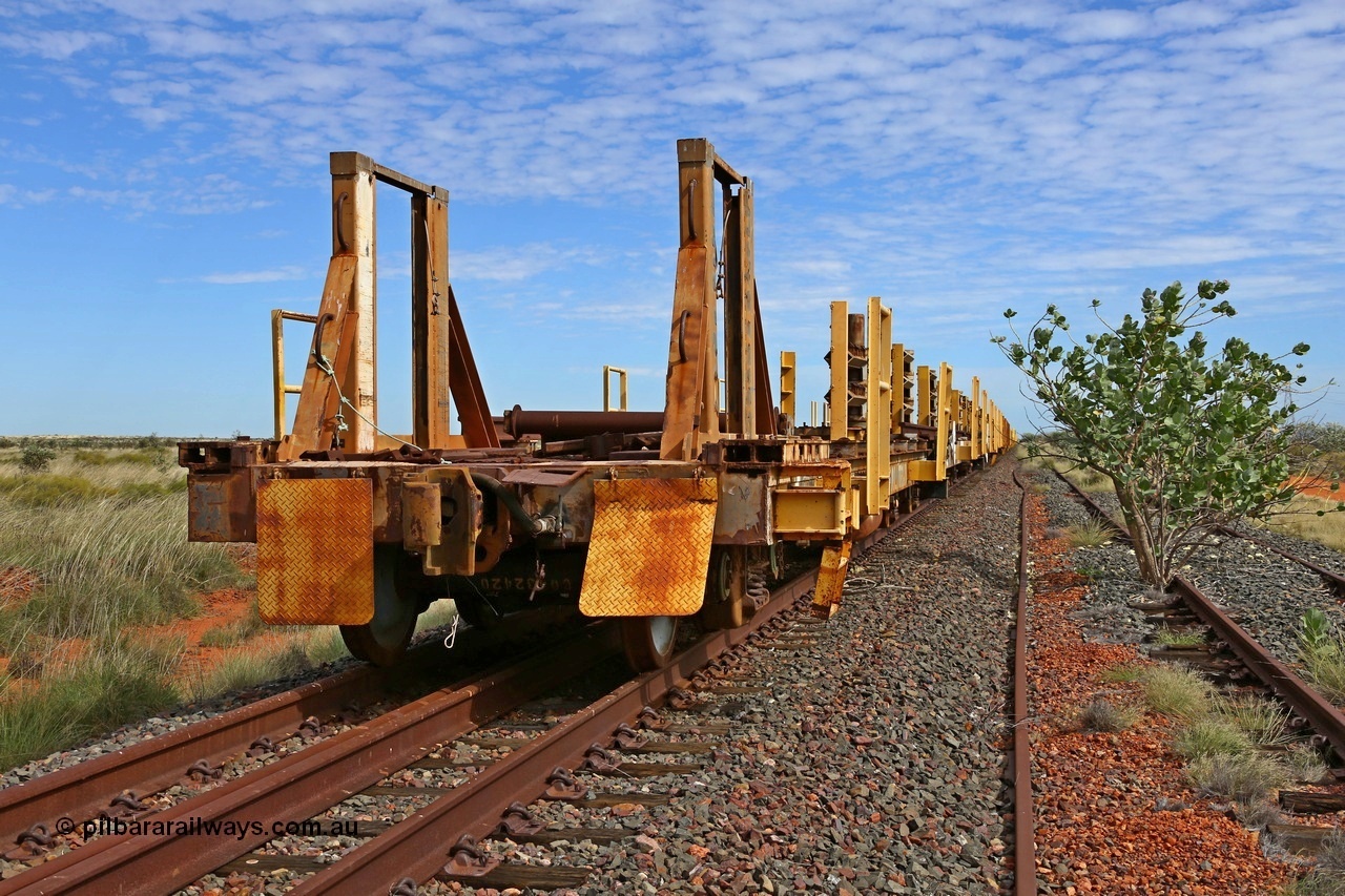 180614 1281
Allen Siding, at the 45 km looking west, the original rail or steel train is stowed on the mainline, looking from the rear lead off waggon 6203, built by Comeng WA in January 1977. The chute arrangement for the discharging and recovery of rail is visible. 14th June 2018. [url=https://goo.gl/maps/UE2dRkZvdBr]GeoData[/url].
