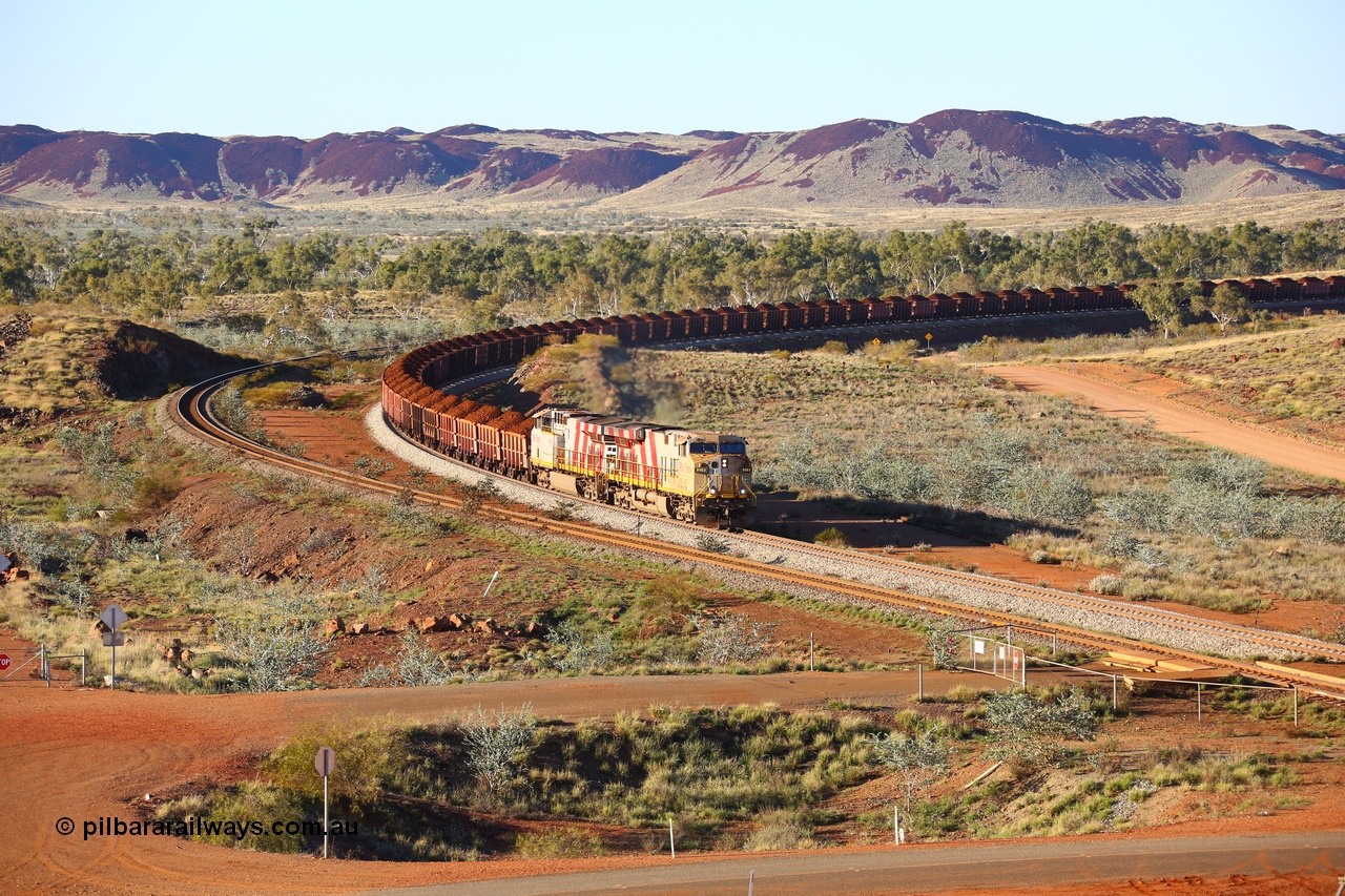180616 1628
Harding Siding, a loaded train from Mesa A behind double Rio Tinto loco 9103 with serial 61941 a GE Erie built GE model ES44ACi from the 1st order in Rio Tinto Stripes livery and 9108 serial 62539 with 167 'J' type ore waggons around the curve at the 38.5 km. 16th June 2018. [url=https://goo.gl/maps/JKiinSDiquy]GeoData[/url]
Toad Montgomery image.
Keywords: 9103;GE;ES44ACi;61941;Rio-Tinto-Stripes;