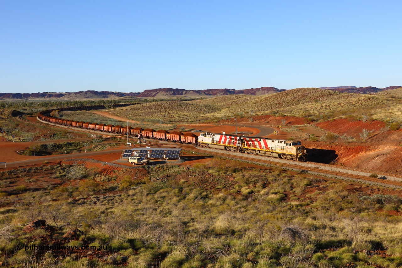 180616 1635
Harding Siding, a loaded train from Mesa A behind double Rio Tinto loco 9103 with serial 61941 a GE Erie built GE model ES44ACi from the 1st order in Rio Tinto Stripes livery and 9108 serial 62539 with 167 'J' type ore waggons rounds the curve at the 38.5 km grade crossing. 16th June 2018. [url=https://goo.gl/maps/JKiinSDiquy]GeoData[/url]
Toad Montgomery image.
Keywords: 9103;GE;ES44ACi;61941;Rio-Tinto-Stripes;