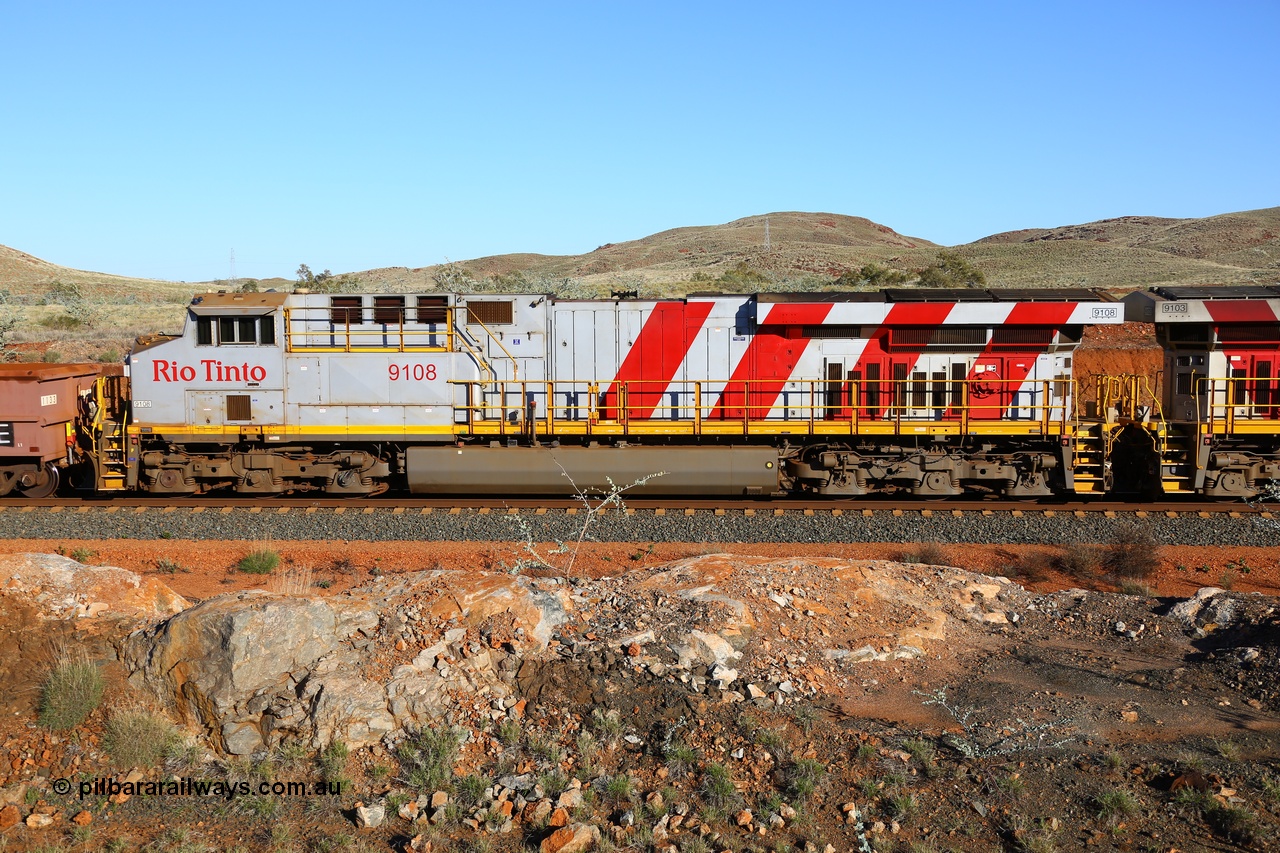180616 1660
Cooya Pooya, 32 km on the Cape Lambert line, Rio Tinto loco 9108 with serial 62539 a GE Erie built GE model ES44ACi from the 2nd order in Rio Tinto Stripes livery side view, following a total loss of air, the train is tied down while the driver walks the consist. The train pulled a coupling around the 45 car position. 16th June 2018. [url=https://goo.gl/maps/ckyFypg4LAy]Geodata[/url]
Keywords: 9108;GE;ES44ACi;62539;Rio-Tinto-Stripes;