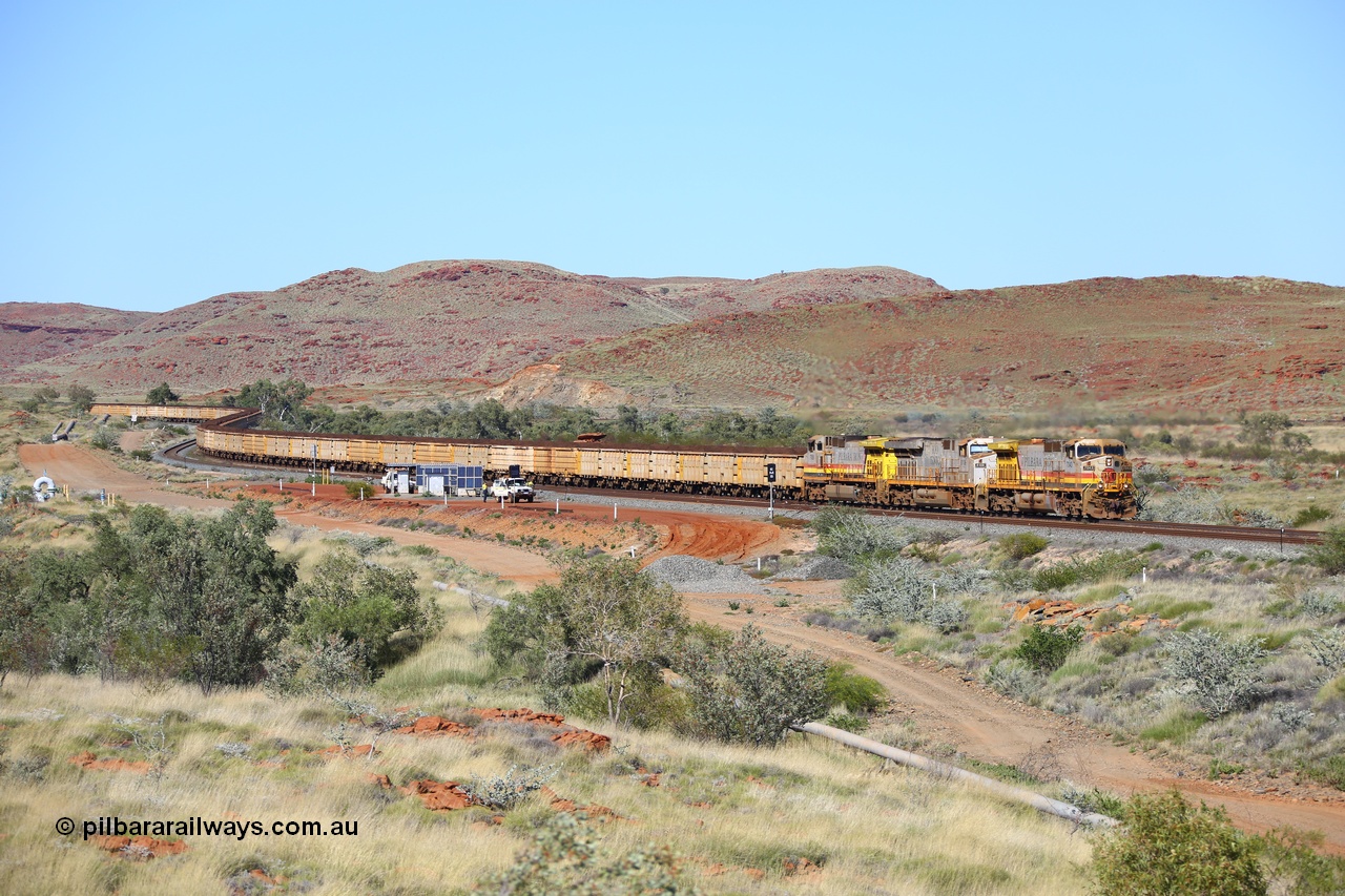 180616 1744
Emu Siding, a loaded train of Q and B series ore waggons behind the lowest numbered Rio Tinto loco 7043 with serial 57094 a GE Erie built GE model Dash 9-44CW from the 10th order in HI Pilbara Iron livery leading an original ES44DCi unit 8108 and sister Dash 9-44CW unit 7058 in the same HI Pilbara Iron livery as they descend the West Mainline past EM7 and EM5 signals at the 74.88 km on they way to Cape Lambert. 16th June 2018. [url=https://goo.gl/maps/fRULDNHPmMo]GeoData[/url].
Keywords: 7043;GE;Dash-9-44CW;57094;HI-Pilbara-Iron;