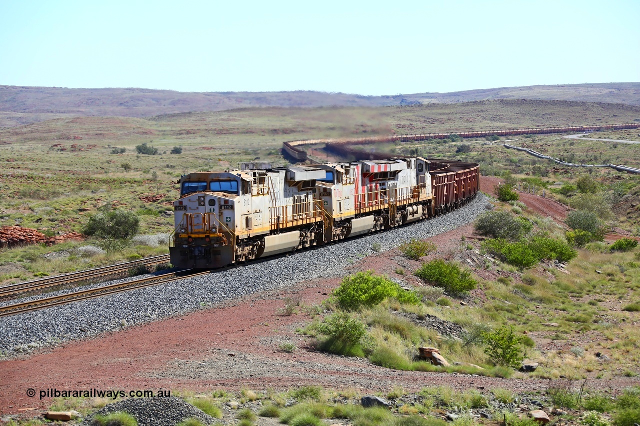 180616 1830
Emu Siding, an empty train from Cape Lambert powers upgrade away from Emu Siding up the 1.6 percent grade behind triple General Electric ES44DCi units Rio Tinto loco 8112 with serial 59104 a GE Erie built GE model ES44DCi from the 2nd order in Rio Tinto livery and 8162 in the Rio Tinto stripes and 8116 in Rio Tinto silver with a consist of S and C type waggons. 16th June 2018. [url=https://goo.gl/maps/M5Nc32gSiLy]GeoData[/url].
Keywords: 8112;GE;ES44DCi;59104;Rio-Tinto;