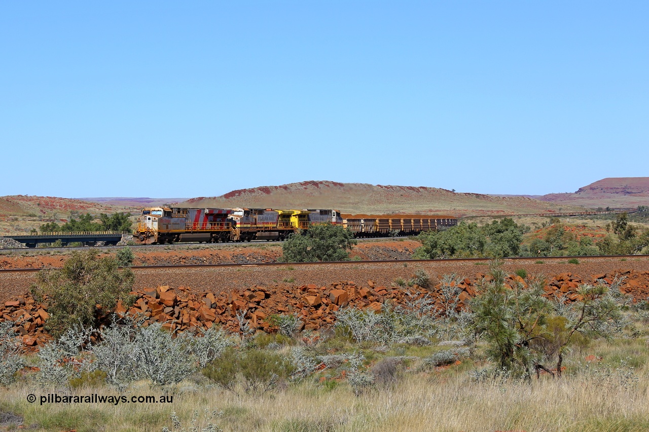 180616 1881
Western Creek, the train on the middle track lead by Rio Tinto loco 8153 with serial 58813 a GE Erie built GE model ES44DCi from the 4th order in Rio Tinto Stripes livery leading two Dash 9-44CW units in the Pilbara Rail livery with ROBE ownership markings with a loaded bound for Cape Lambert and running on the Western Creek West mainline at the 74 km with the bridges over Western Creek and the train stretching back up into Emu Siding. The track in the foreground is the mainline to Dampier with the line in the background the Western Creek East mainline to Cape Lambert. 16th June 2018. [url=https://goo.gl/maps/rH9HZ4CCSS82]GeoData[/url].
Keywords: 8153;GE;ES44DCi;58813;Rio-Tinto-Stripes;