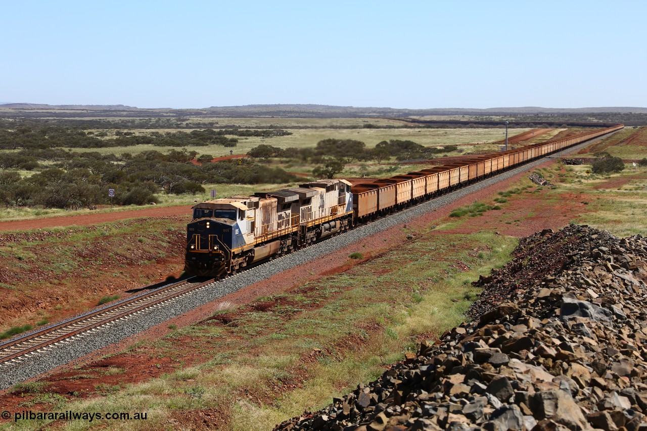 150505 7959
FMG Solomon Line, a pair of General Electric Dash 9-44CW locomotives 005 serial 58182 and 006 serial 58183 struggle upgrade with a loaded train at the 227 km bound for Port Hedland, the train is being assisted in the rear. Geodata: [url=https://goo.gl/maps/NjHo38Gc7kE2] -22.0189283 118.5861050 [/url].
Keywords: FMG-005;GE;Dash-9-44CW;58182;FMG-006;58183;