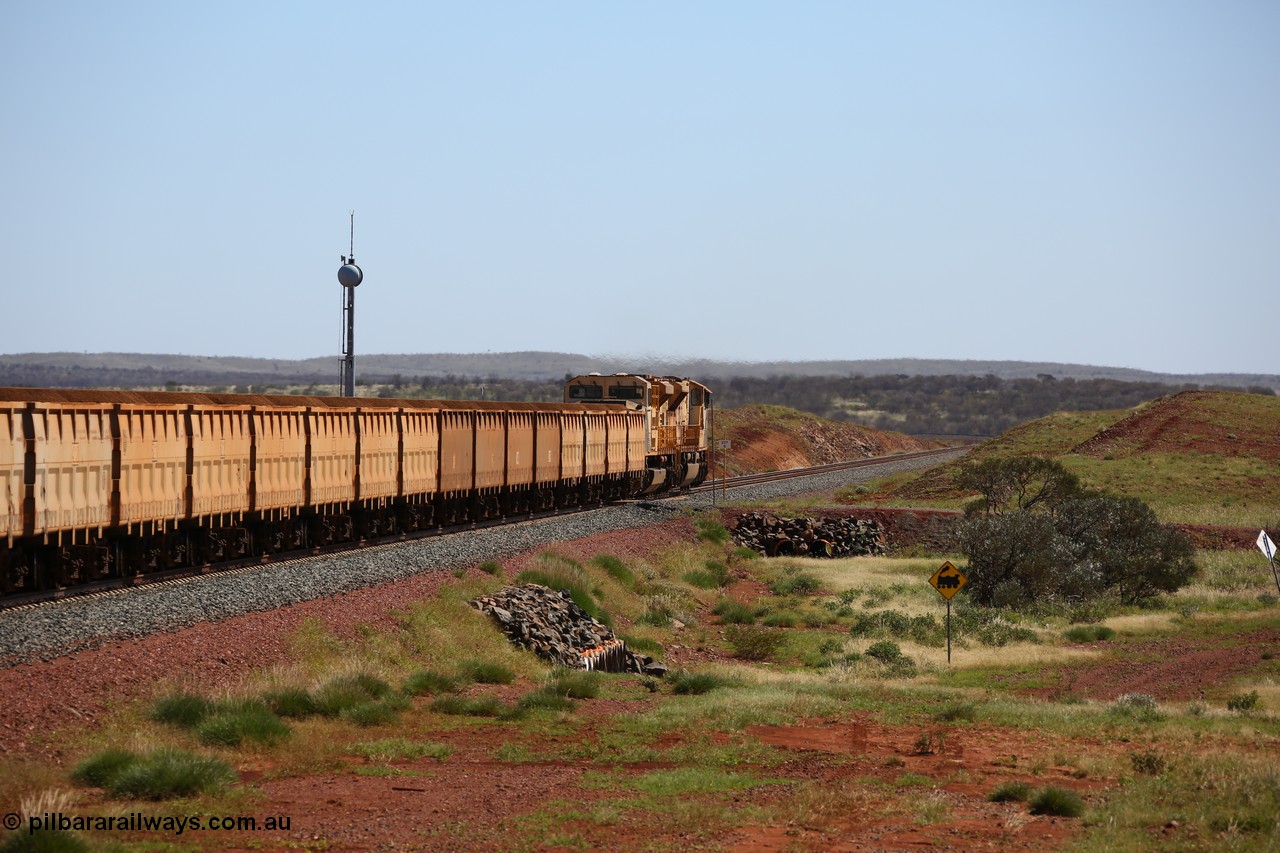 150505 7982
FMG Solomon Line, bank engines Progress Rail EMD SD70ACe/LCi unit 716 serial 20118693-008 and EMD SD90MAC unit 901 serial 976833-1, this unit has been repowered with an 16-710G3 prime mover, cross the 227.5 km grade crossing as they shove the loaded train upgrade at an increasing speed as the front of the train has topped the grade. Geodata: [url=https://goo.gl/maps/gSzXJkmY3ux] -22.0187117 118.5850933 [/url].
Keywords: FMG-716;Progress-Rail-Muncie-USA;EMD;SD70ACe/LCi;FMG-901;SD90MAC-H2;