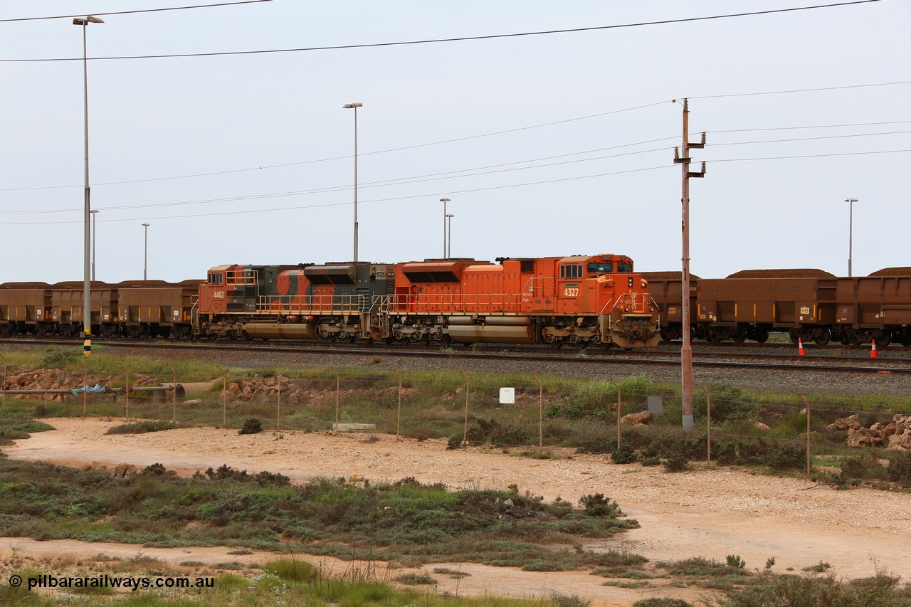 150523 8197
Nelson Point Yard, a pair of BHP Billiton SD70ACe units waits in the arrival yard with a loaded rake for the dumpers. Lead unit 4327 'Hamersley' is from an order originally built by Electro-Motive, London Ontario for BNSF, a US Class 1 railroad, but BHP secured 10 of them during construction, this unit 4327 serial 20066862-056 was destined to be BNSF 9185 before coming to BHP. The second unit 4402 is from a batch of Progress Rail EMD SD70ACe units serial 20118575-012.
