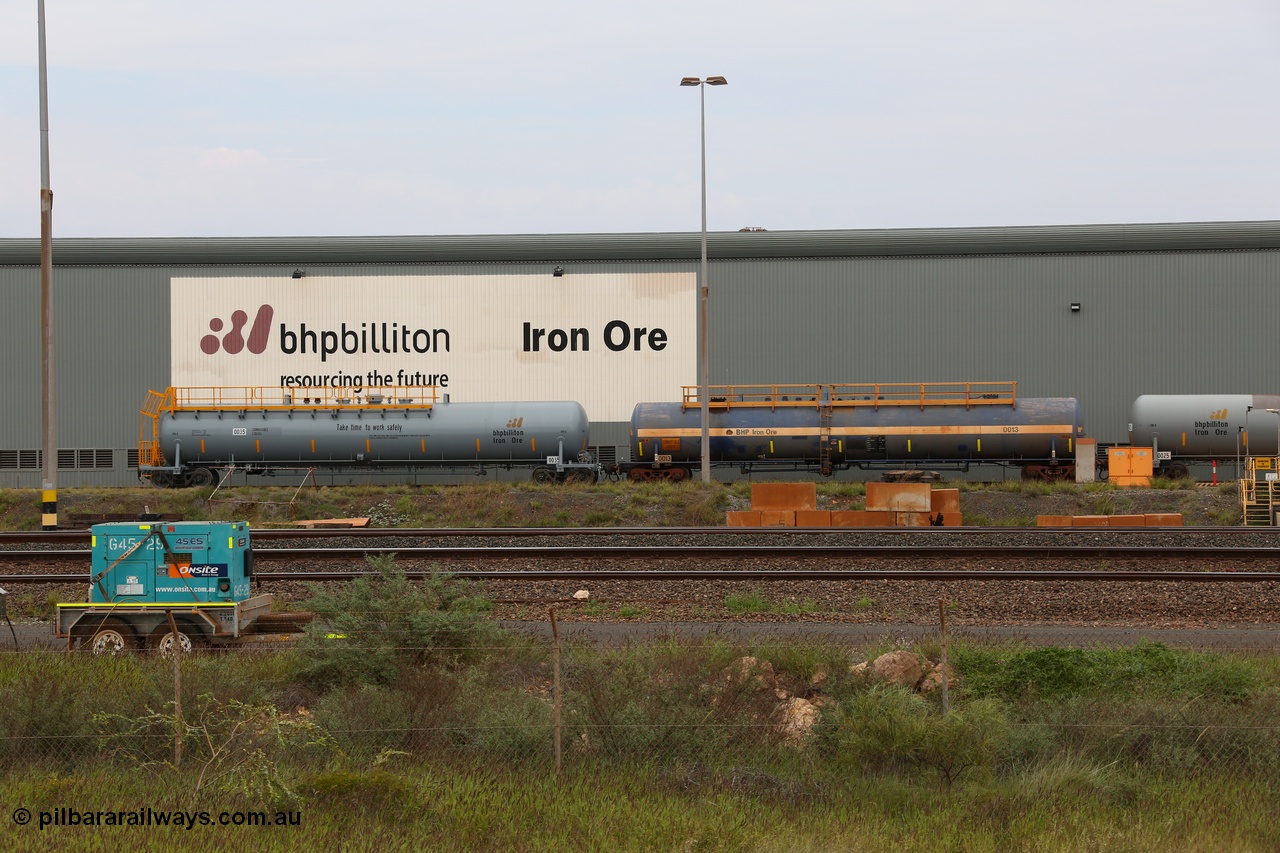 150523 8205
Nelson Point Yard, parked beside the Locomotive Service Shop, new style BHP Billiton diesel fuel tank waggon 0035 with safety slogan 'Take time to work safety', total capacity of 117 m3 for a nominal capacity of 113 m3 built in China by CNR - QRRS and fitted with ECPB coupled to original fuel tank waggon number 0013 built by Comeng with a 113649 litre capacity.
Keywords: CNR-QRRS-China;BHP-tank-waggon;Comeng-NSW;