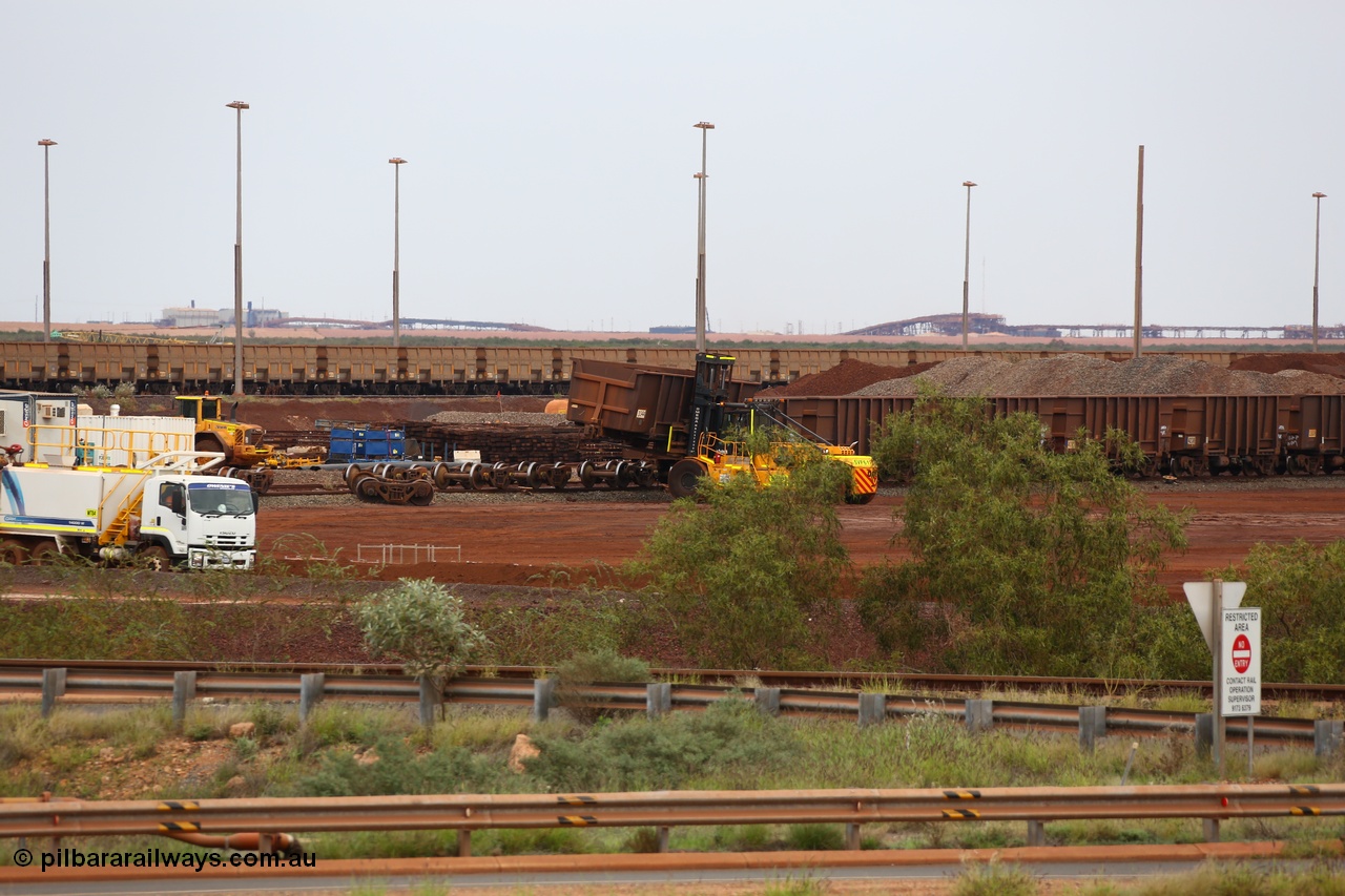 150523 8232
Nelson Point Yard, I Area, waggon scrapping by Sims Metal, a fork lift carries waggon no. 3340, one of 350 waggons built in Romania of which only about 60 made it into service, the rest rusting away in a caged embargo area out on the Broome Road until they were scrapped some years ago. There is a connection with these waggons and Lang Hancock and his former mine McCamey's Monster, now known as Jimblebar.
Keywords: Arad-Romania;BHP-ore-waggon;