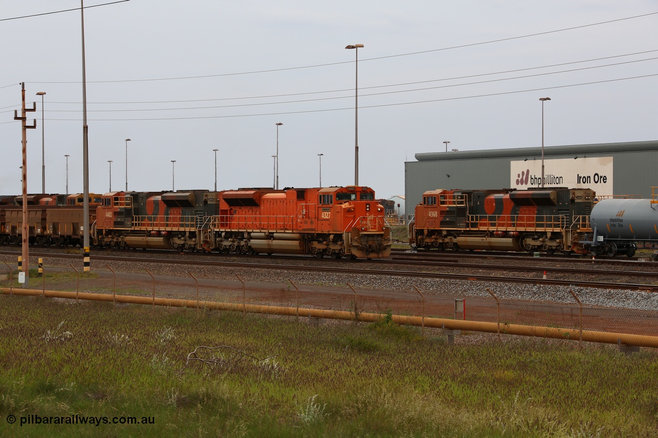 150523 8236
Nelson Point Yard, BHP Billiton SD70ACe unit leads a rake towards the dumpers. Lead unit 4327 'Hamersley' is from an order originally being built by Electro-Motive, London Ontario for BNSF, an US class 1 railroad, but BHP secured 10 of them during construction, this unit 4327 serial no. 20066862-056 was destined to be BNSF 9185 before coming to BHP, passes SD70ACe unit 4368 on the fuel tank shunt, a unit from the last order of 18 SD70ACe units for BHP Billiton from Electro-Motive, London Ontario, serial no. 20098203-013.
