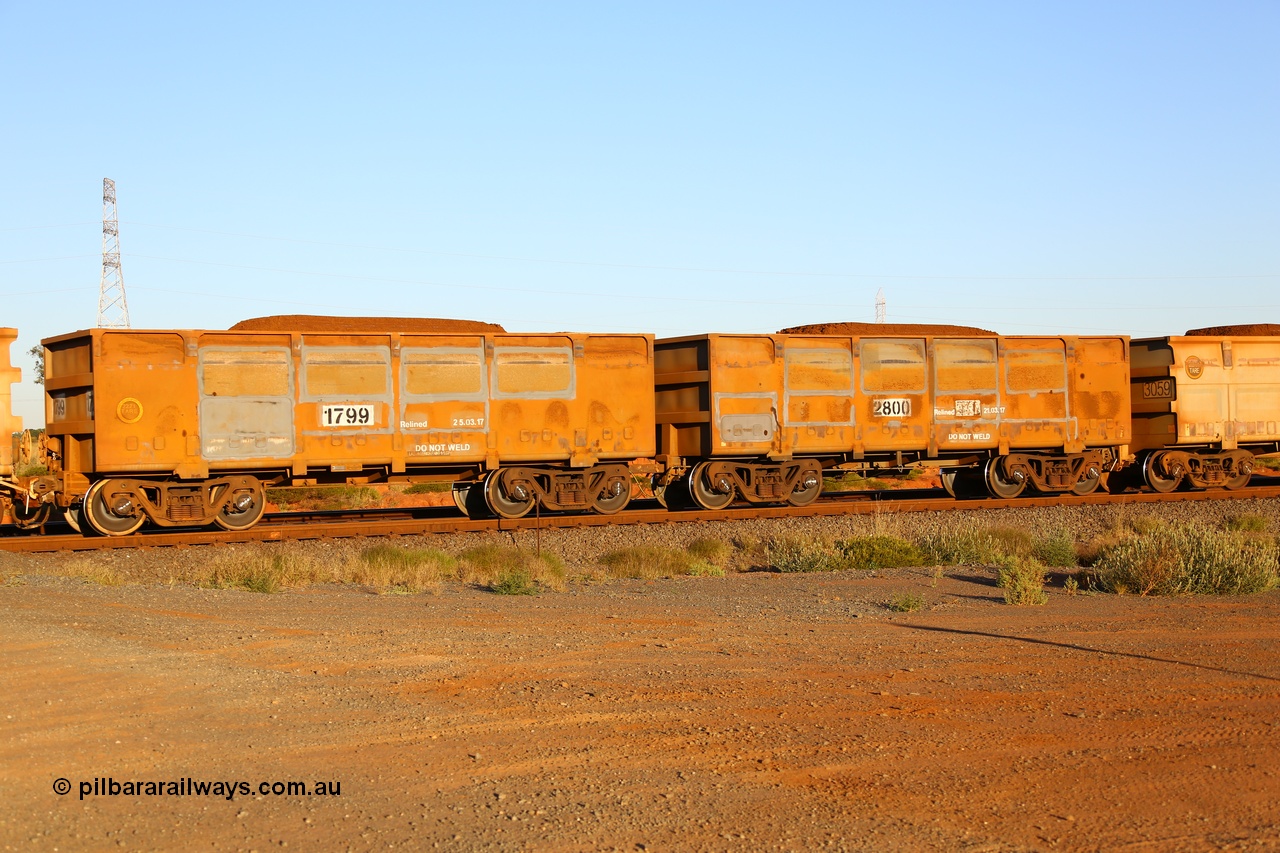 170726 9457
Boodarie, FMG ore waggon pair 2800 (control) and 1799 (slave) of the original design and loaded with fines ore shows evidence of side wall panel replacement and new relining dates. 26th July 2017.
