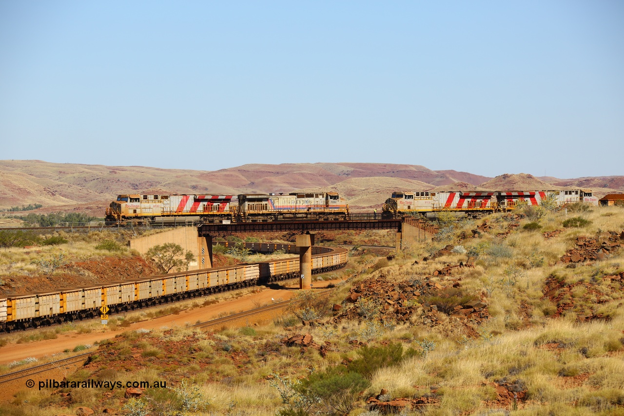 170728 09819
Western Creek, a disabled train from Mesa A on the right behind ES44ACi unit 9103 has relief locos 7082 serial 47761 a General Electric built Dash 9-44CW and a General Electric built ES44DCi unit 8137 ease up to couple onto 9103s disabled train. This image shows all these models of locomotive on the Rio Tinto mainline roster as an empty train climbs upgrade under the bridge. 28th July 2017. [url=https://goo.gl/maps/n4HzBo2eGrz]GeoData[/url].
Keywords: 7082;GE;Dash-9-44CW;47761;