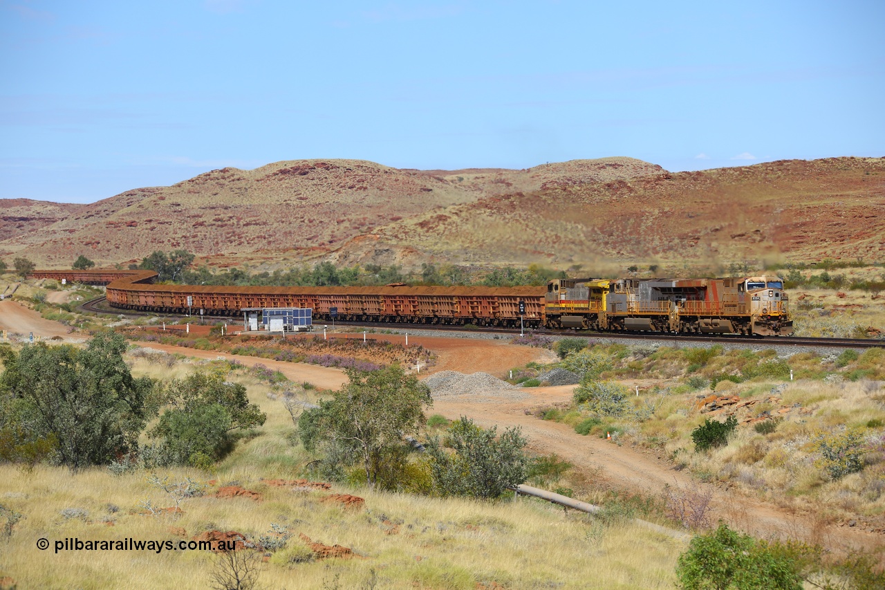 170729 0145
Emu Siding, a loaded Rio Tinto train rolls down grade past the signals at the 74.8 km West Mainline behind Rio Tinto stripe liveried General Electric built ES44DCi unit 8194 serial 61853 and plain silver sister unit 8111 and Dash 9-44CW stablemate 7055 as they head to the Cape Lambert port for unloading. 29th July 2017. [url=https://goo.gl/maps/ad5sT7twQUq]GeoData[/url]
Keywords: 8194;GE;ES44DCi;61853;