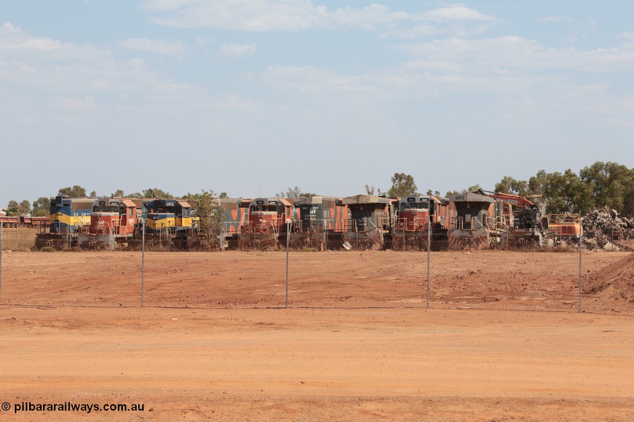 141025 5818
Wedgefield, WA, view from the new bypass road looking into the rear of Sell and Parker's metal recycling yard with former BHP Billiton Iron Ore EMD SD40, SD40R and GE AC6000 model units lined up awaiting their fate, from left, EMD SD40 3080, SD40R 3097, SD40 3078, SD40R 3088, 3086, 3094, AC6000 6075, SD40R 3091, AC6000 6073 and remains of another SD40R.
Keywords: SD40;SD40R;EMD;AC6000;GE;
