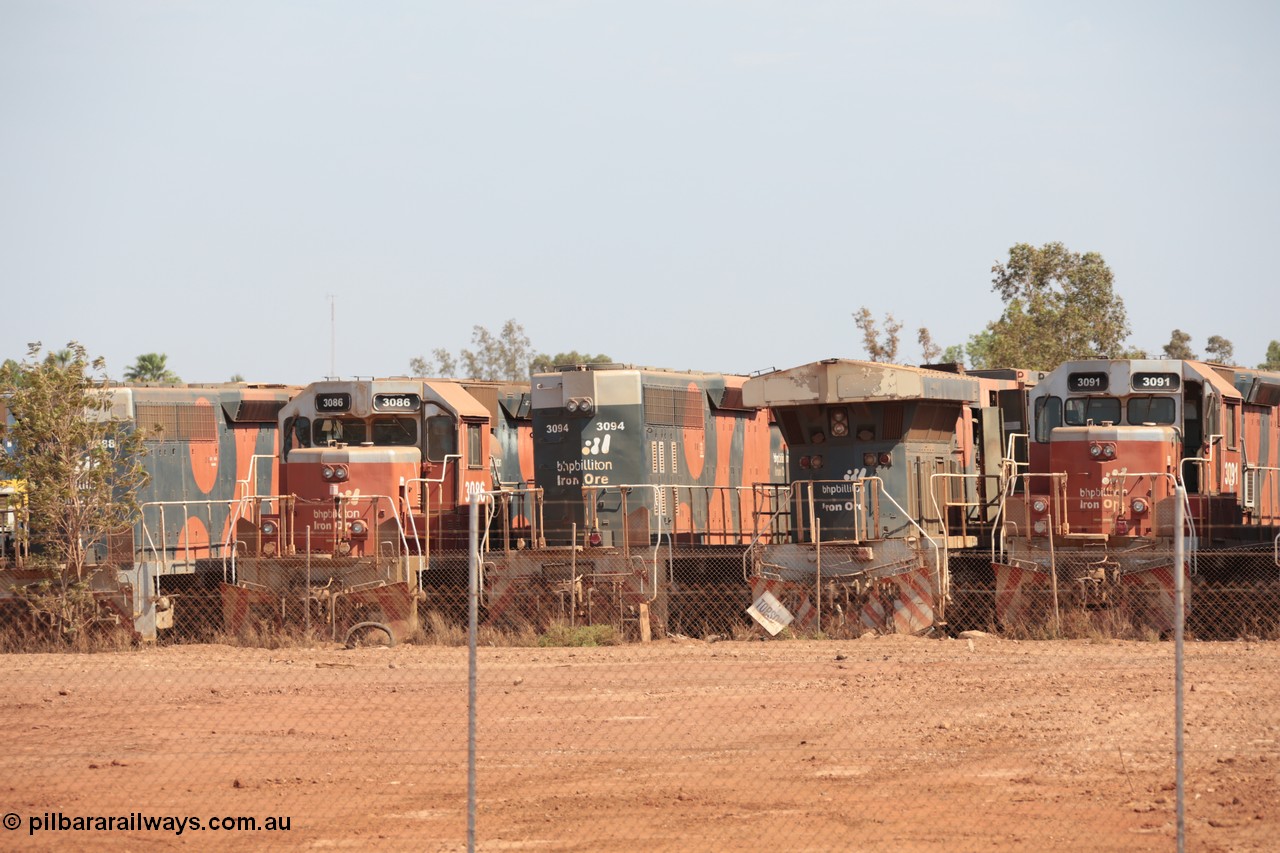 141025 5820
Wedgefield, WA, view from the new bypass road looking into the rear of Sell and Parker's metal recycling yard with former BHP Billiton Iron Ore EMD SD40R and GE AC6000 model units lined up awaiting their fate, from left, EMD SD40R 3088, 3086, 3094, AC6000 6075, SD40R 3091.
Keywords: SD40R;3086;3094;3091;EMD;31491;31515/7861-25;31496/7861-6;