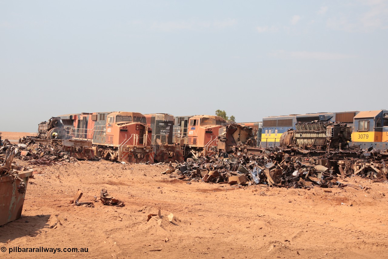 141027 5825
Wedgefield, view out the back of Sell and Parker's metal recycling yard shows a sorry sight. From left is the frame of an SD40R and prime mover, AC6000 6073, SD40R 3091, AC6000 6075 and SD40 3079. Beside 3079 is the remains of AC6000 unit 6071 having been reduced from one of the most powerful locomotives to work in Australia to a munched up tangled mass of metal, the EVO motor is still in the frame.
Keywords: S+P;6073;6075;3079;GE;AC6000;EMD;SD40R;51065;51067;31542/7861-52;
