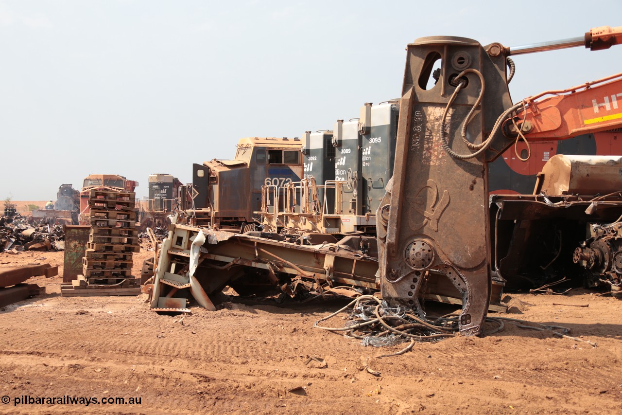 141027 5862
Wedgefield, Sell and Parker's metal recycling yard, General Electric AC6000 unit 6072 looks on next to EMD SD40R units 3092, 3089 and 3095, a frame segment of an SD40R and the hydraulic shears.
