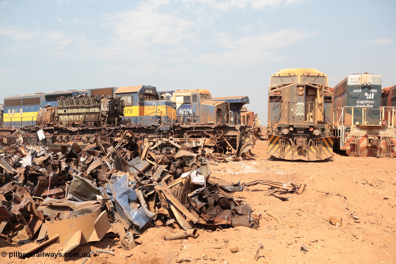 141027 5869
Wedgefield, Sell and Parker's metal recycling yard, GE AC6000 unit 6071 is just a frame and 6600 hp EVO motor as EMD SD40 3079 and other AC6000 units 6074 and 6072 look on.
