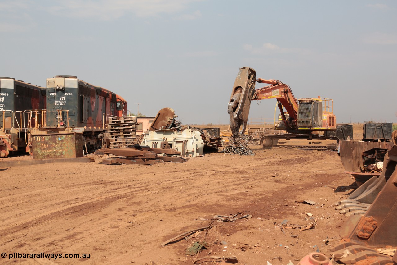 141027 5912
Wedgefield, Sell and Parker's metal recycling yard, view of Hitachi ZAXIS 350 LCH excavator fitted with the huge hydraulically operated shears that are making a meal of former EMD SD40 and GE AC6000 locomotives. Besides it lays the remains of an EMD SD40R unit which has been reduced to a few frame part with the EMD 645 engine laying over, sister units 3095 wait for a similar fate.
