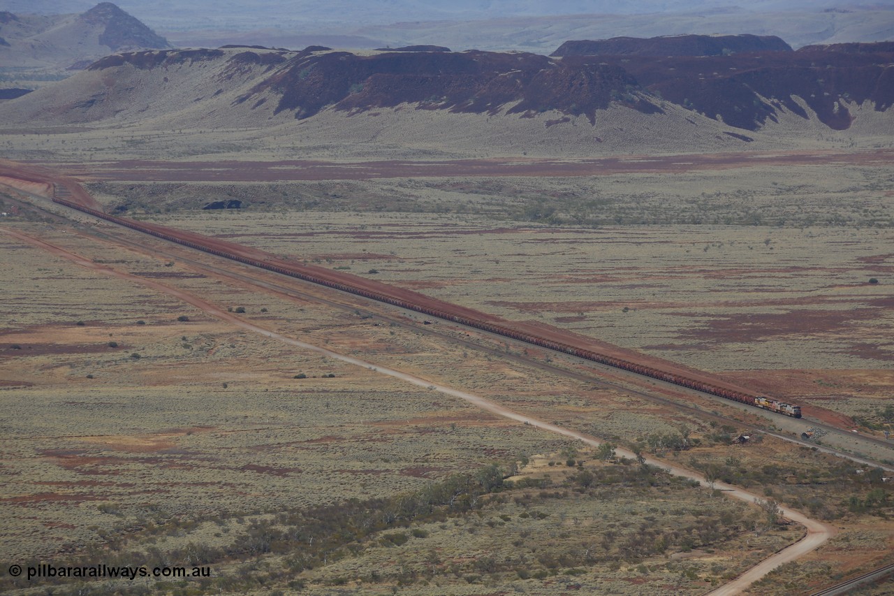 151111 9507
A loaded train behind General Electric ES44DCi units 8113 serial 59105 in the original silver livery and 8145 serial 58726 in the tiger strip Rio livery and Dash 9-44CW 9433 serial 54766 in ROBE Pilbara Iron livery runs along on the West Mainline bound for Cape Lambert viewed from Table Hill.
Keywords: 8113;GE;ES44DCi;59105;