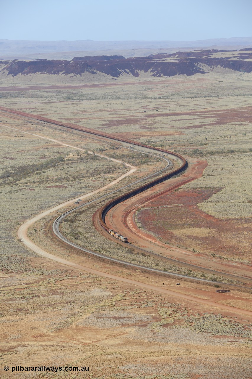 151111 9510
A loaded train behind General Electric ES44DCi units 8113 serial 59105 in the original silver livery and 8145 serial 58726 in the tiger strip Rio livery and Dash 9-44CW 9433 serial 54766 in ROBE Pilbara Iron livery runs along on the West Mainline bound for Cape Lambert viewed from Table Hill.
Keywords: 8113;GE;ES44DCi;59105;