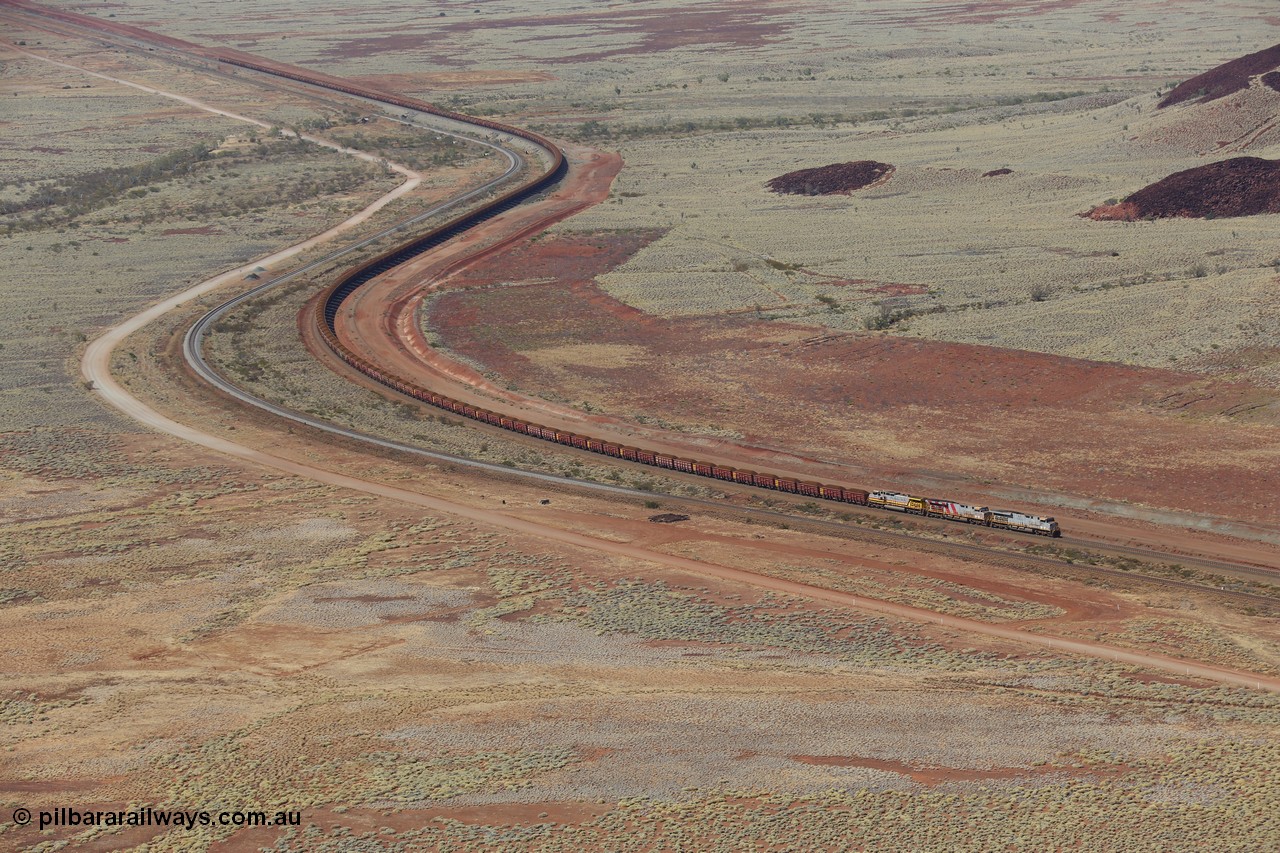 151111 9515
A loaded train behind General Electric ES44DCi units 8113 serial 59105 in the original silver livery and 8145 serial 58726 in the tiger strip Rio livery and Dash 9-44CW 9433 serial 54766 in ROBE Pilbara Iron livery runs along on the West Mainline bound for Cape Lambert viewed from Table Hill.
Keywords: 8113;GE;ES44DCi;59105;