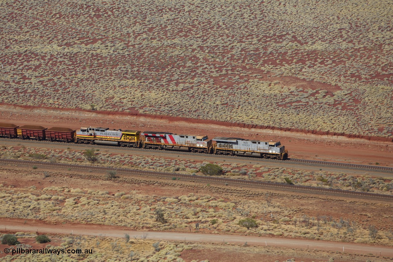 151111 9520
A loaded train behind General Electric ES44DCi units 8113 serial 59105 in the original silver livery and 8145 serial 58726 in the tiger strip Rio livery and Dash 9-44CW 9433 serial 54766 in ROBE Pilbara Iron livery runs along on the West Mainline bound for Cape Lambert viewed from Table Hill.
Keywords: 8113;GE;ES44DCi;59105;