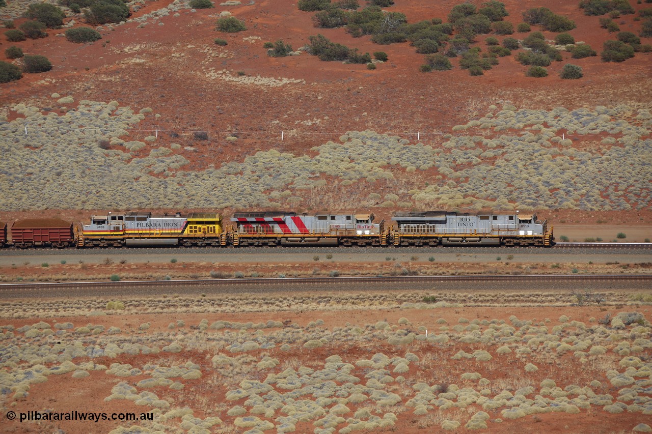 151111 9528
A loaded train behind General Electric ES44DCi units 8113 serial 59105 in the original silver livery and 8145 serial 58726 in the tiger strip Rio livery and Dash 9-44CW 9433 serial 54766 in ROBE Pilbara Iron livery runs along on the West Mainline bound for Cape Lambert viewed from Table Hill.
Keywords: 8113;GE;ES44DCi;59105;