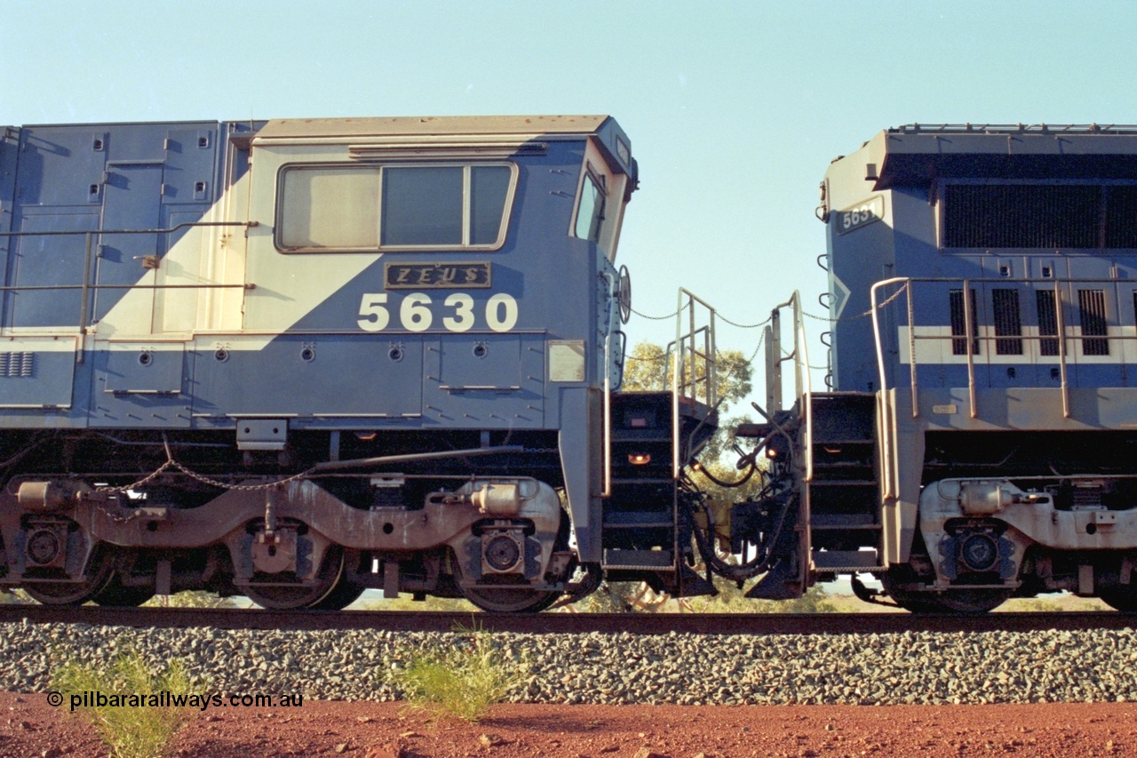 196-07
Yandi Two, BHP Iron Ore 5630 'Zeus' serial 5831-09 / 88-079 originally built new by Goninan as a GE CM39-8 in 1988. Drivers side cab view shows hand brake chain and bogie. May 1998.
Keywords: 5630;Goninan;GE;CM39-8;5831-09/88-079;