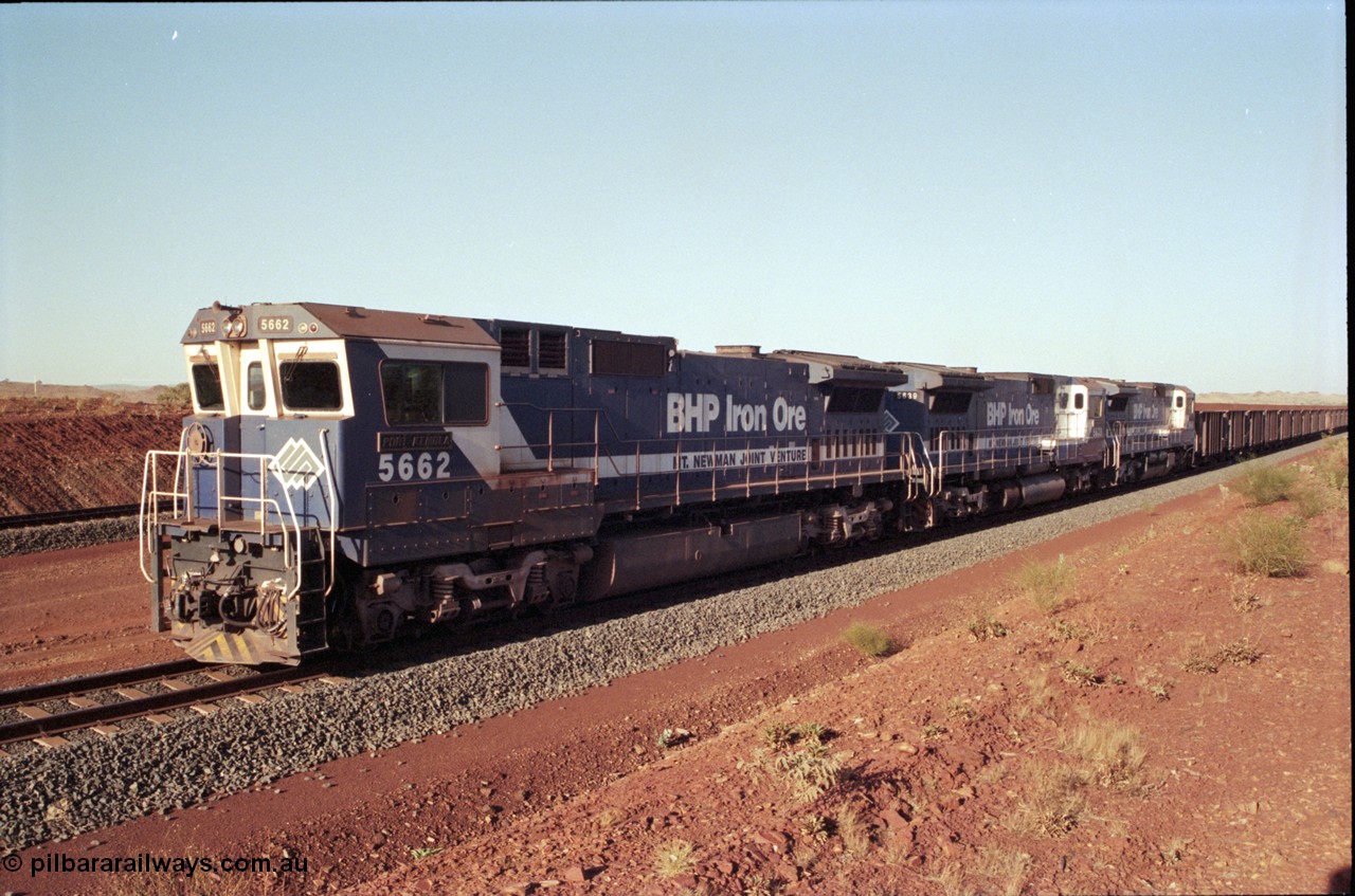 196-17
Yandi Two loaded car side of the loadout balloon loop, loaded train departing behind BHP Iron Ore triple CM40-8M units, 5662 'Port Kembla' serial 8412-07 / 94-153 rebuilt by Goninan in 1994 from Comeng NSW built ALCo M636C number 5490 serial C6084-6 from 1974, leading two similar sister units. May 1998.
Keywords: 5662;Goninan;GE;CM40-8M;8412-07/94-153;rebuild;Comeng-NSW;ALCo;M636C;5490;C6084-6;