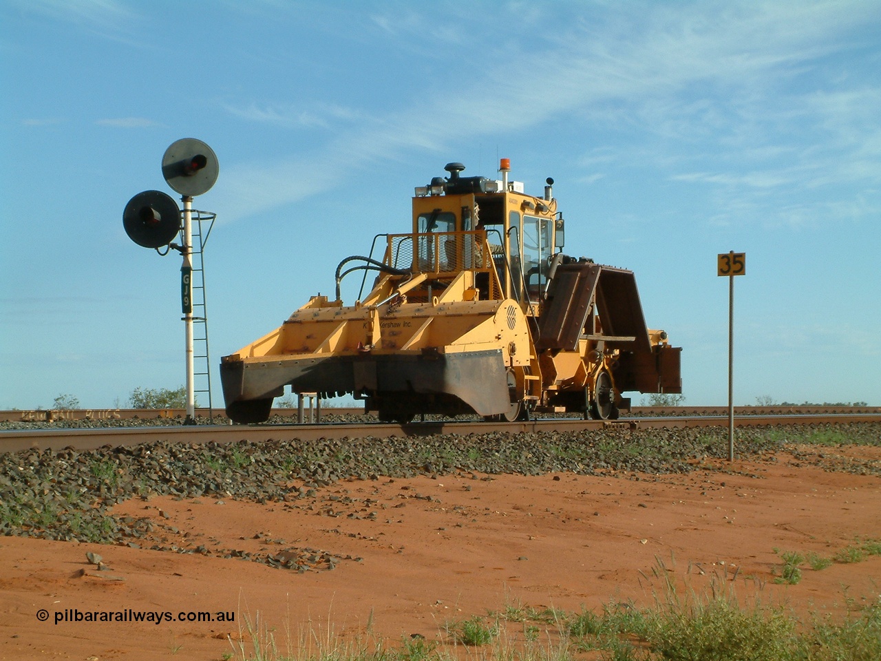 040407 073324
Goldsworthy Junction, Barclay Mowlem's R.E.L.A.M lease ballast plough, Knox Kershaw KBR 850 model travels east along the Goldsworthy line past the dual headed GJ 9 signal. 7th April 2004
Keywords: Knox-Kershaw;KBR-850;track-machine;