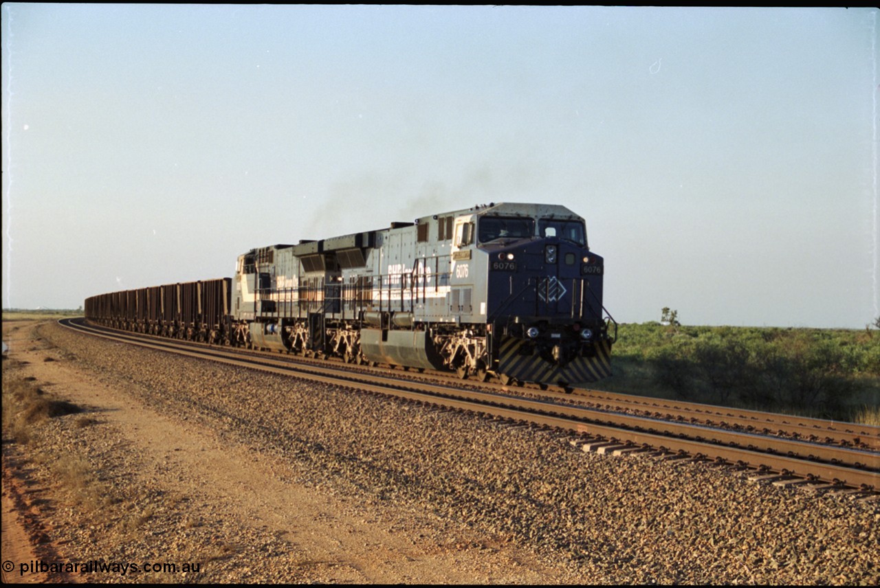 203-03
Bing Siding, an empty train behind a pair of BHP General Electric AC6000 units 6076 'Mt Goldsworthy' serial 51068 and class leader 6070 'Port Hedland' serial 51062 run around the passing track up to the departure signal.
Keywords: 6076;GE;AC6000;51068;