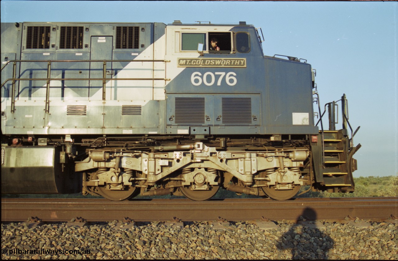 203-11
Bing Siding, BHP Iron Ore General Electric AC6000 model 6076 'Mt Goldsworthy' serial 51068 with an empty train. Cab side view with name board, steerable bogie and Driver Cosgrove at the controls.
Keywords: 6076;GE;AC6000;51068;
