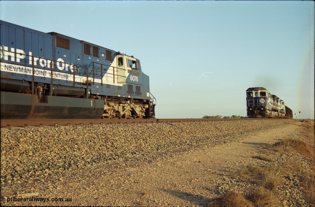 203-13
Bing Siding, a loaded BHP Iron Ore train with a pair of CM40-8M units on the lead are on the mainline as the cross the empty train behind General Electric AC6000 unit 6076 'Mt Goldsworthy' serial 51068.
Keywords: 6076;GE;AC6000;51068;