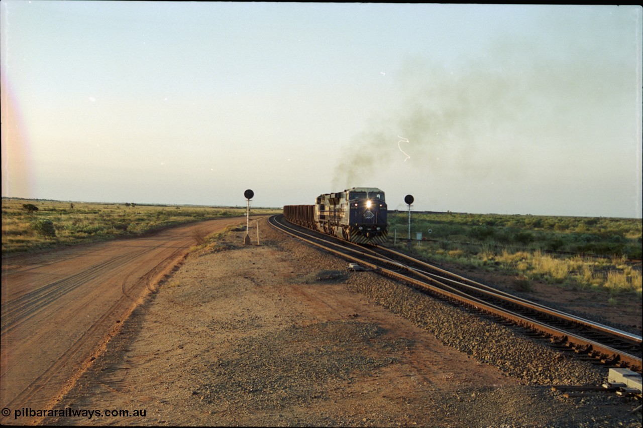 203-18
Bing Siding, with the empty clear, BHP General Electric AC6000 unit 6076 'Mt Goldsworthy' serial 51068 powers its' train out of the passing track at Bing South.
Keywords: 6076;GE;AC6000;51068;
