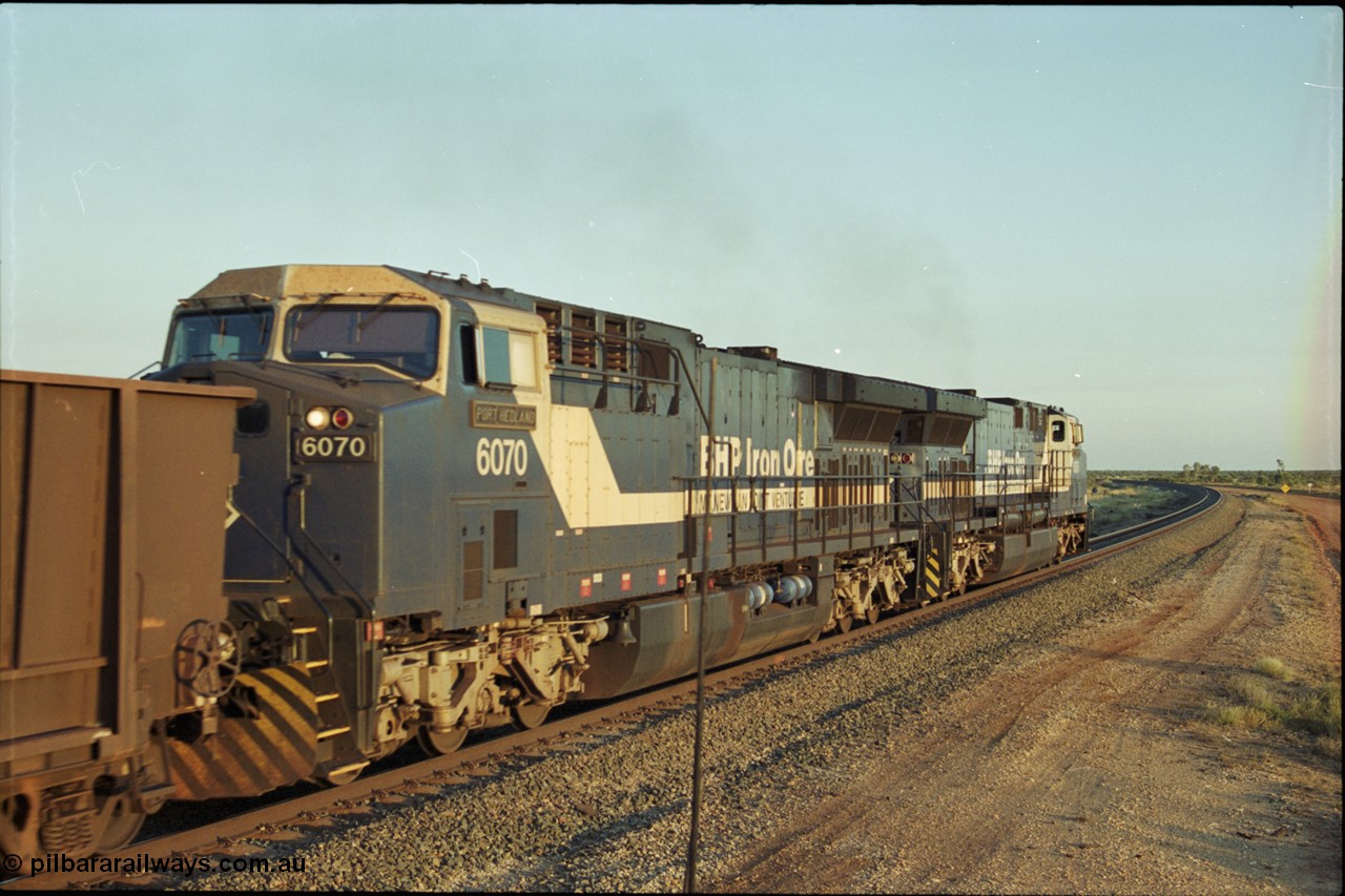 203-21
Bing Siding, with the empty clear, BHP General Electric AC6000 unit 6076 'Mt Goldsworthy' serial 51068 leading class leader 6070 'Port Hedland' serial 51062 as they power their train out of the passing track at Bing South.
Keywords: 6070;GE;AC6000;51062;