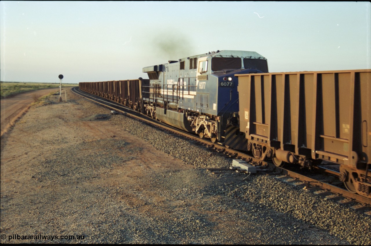 203-24
Bing Siding, min-train unit on an empty Yandi working BHP General Electric built AC6000 6077 'Nimingarra' serial 51069 with the second style of PVC type windscreen protectors fitted.
Keywords: 6077;GE;AC6000;51069;