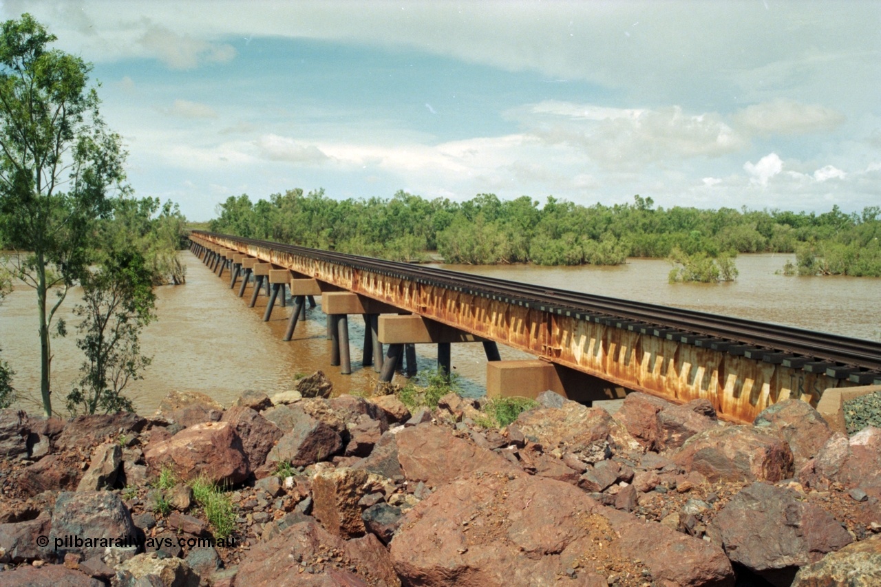 218-03
De Grey River Bridge, former road and rail, now only rail bridge for the Goldsworthy line, looking east, river is in flood.

