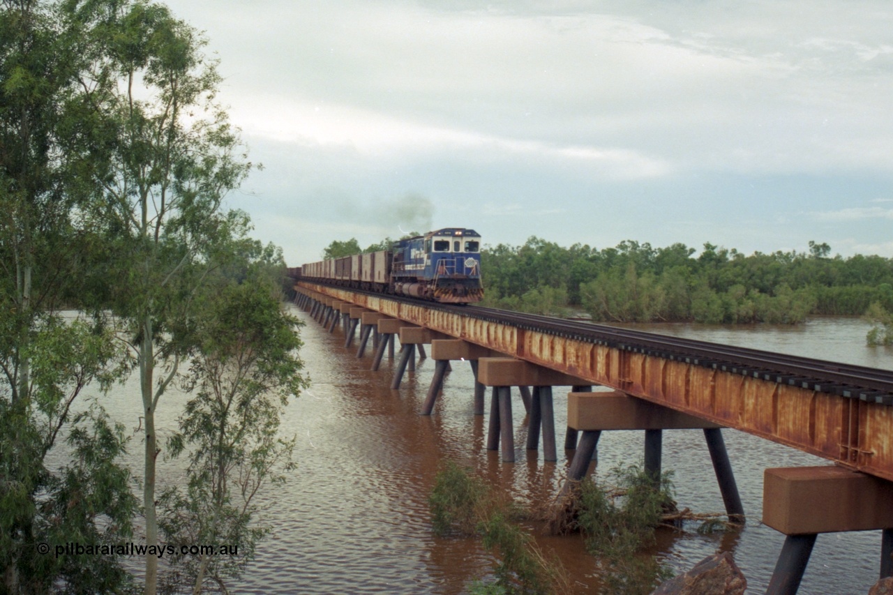 218-10
De Grey River Bridge, a loaded Yarrie train crosses the river behind an original Mt Newman Mining ALCo to GE rebuild carried out by Goninan, originally ALCo C636 5458 to GE model C36-7M unit 5510 'Newman' serial 4839-07 / 87-075.
Keywords: 5510;Goninan;GE;C36-7M;4839-07/87-075;rebuild;AE-Goodwin;ALCO;C636;5458;G6027-2;