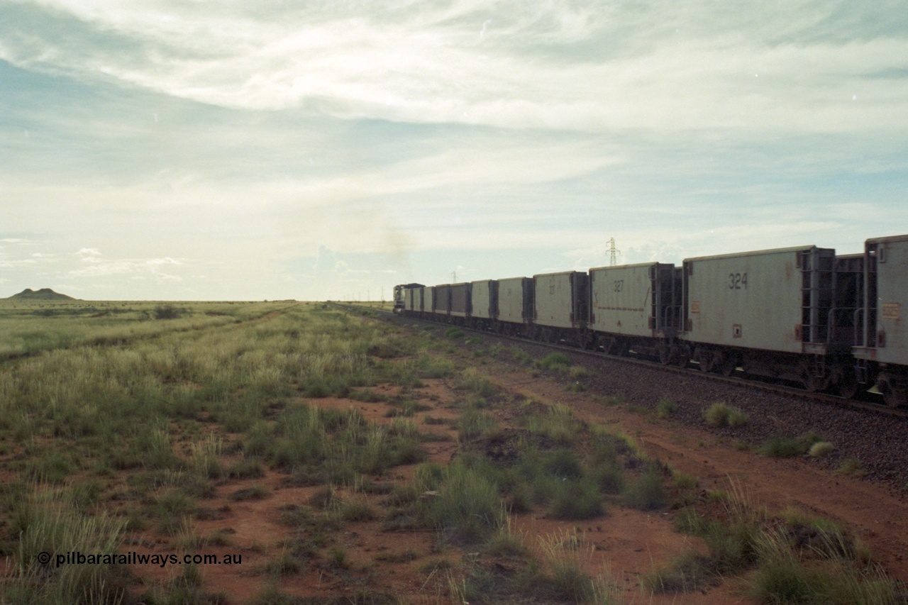 218-25
De Grey, Great Northern Highway grade crossing at the 57.15 km a loaded GML train with Gunderson USA (smooth) and Portec USA (ribbed) built waggon behind the C36-7M loco. The waggons are ex-Phelps Dodge Copper Mine.
