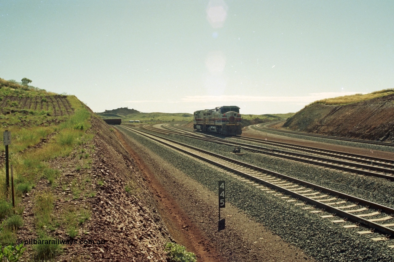 218-37
Yandicoogina or HIY as Hamersley Iron identify it, located 445 km from Parker Point yard in Dampier. Bank engine units General Electric Dash 9-44CW models 7089 serial 47768 and 7090 wait their next loaded train to push out, the tail of which is visible on the left with the mine stockpile in the background.
Keywords: 7090;GE;Dash-9-44CW;47769;