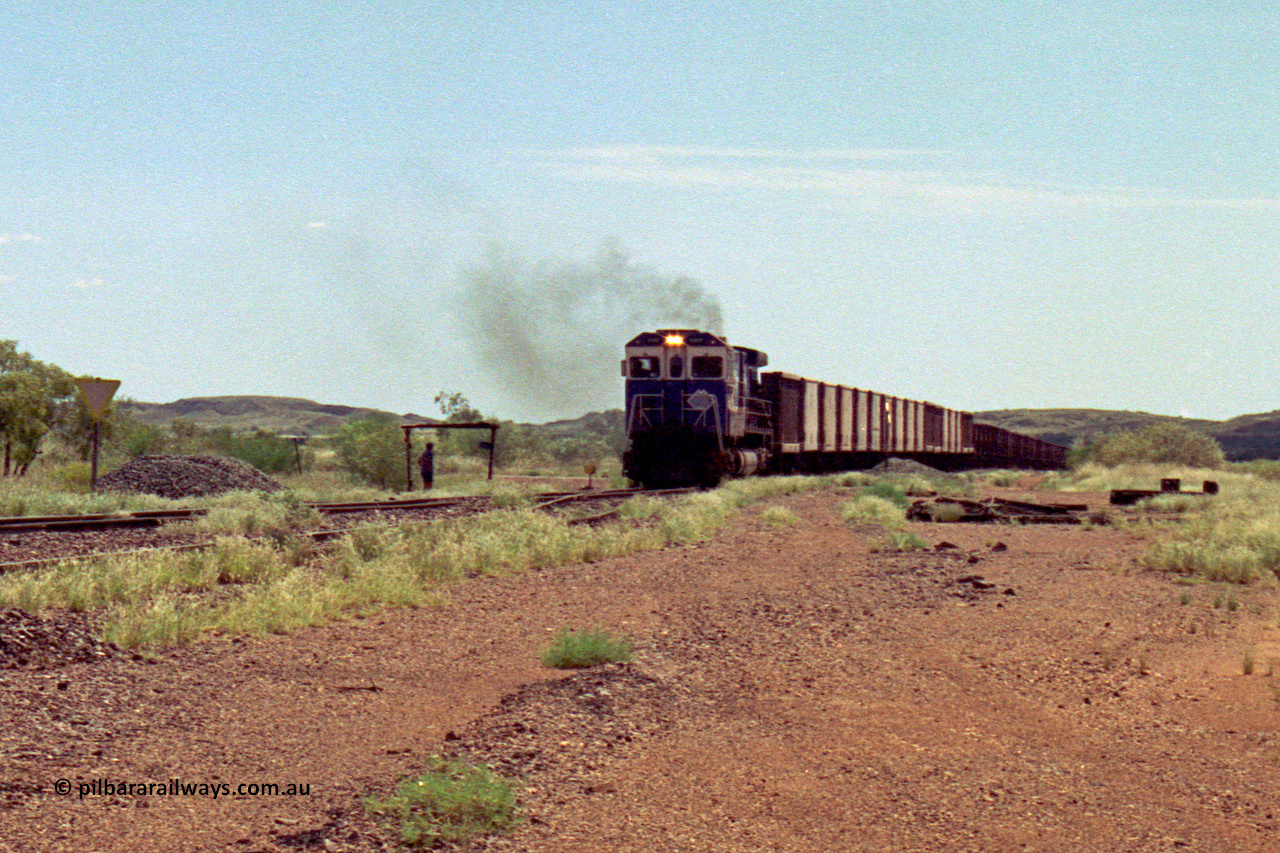 219-26
Goldsworthy Siding, C36-7M unit 5507 'Nimingarra' serial 4839-03 / 87-072, an original Mt Newman Mining ALCo C636 5461 to GE C36-7M rebuild carried out by Goninan, leads an empty train into the siding at Goldsworthy as the second driver watches the roll by under the shelter.
Keywords: 5507;Goninan;GE;C36-7M;4839-03/87-072;rebuild;AE-Goodwin;ALCo;C636;5461;G6035-2;