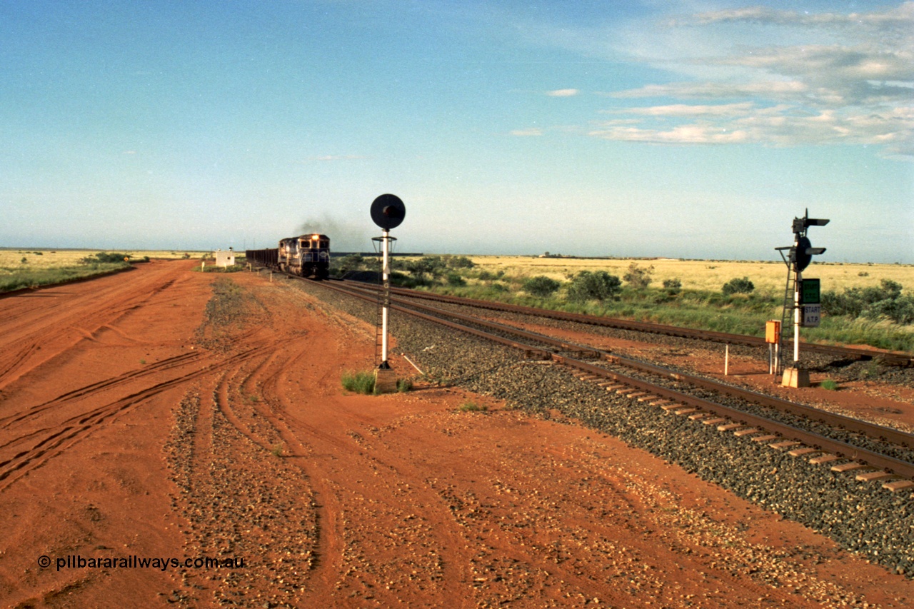 220-30
Goldsworthy Junction, the afternoon empty departure for Yandi mine behind the standard double Dash 8 power consist of 5649 'Pohang' a Goninan GE rebuild CM40-8M model serial 8412-07 / 93-140 and a sister unit, the line merging from the right is the former Goldsworthy line from Yarrie and Nimingarra mines. This area is now fully duplicated with LED signals and the Dash 8 units have been scrapped.
Keywords: 5649;Goninan;GE;CM40-8M;8412-07/93-140;rebuild;AE-Goodwin;ALCo;M636C;5473;G6047-5;