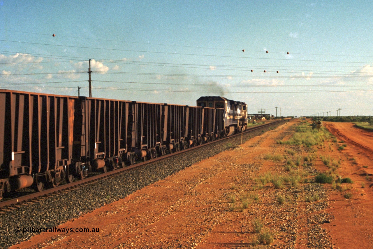 220-32
Goldsworthy Junction, trailing shot of the afternoon departure for Yandi mine behind the standard double Dash 8 power consist, heading towards Bing Siding with the Flashbutt Yard visible in the distance.
