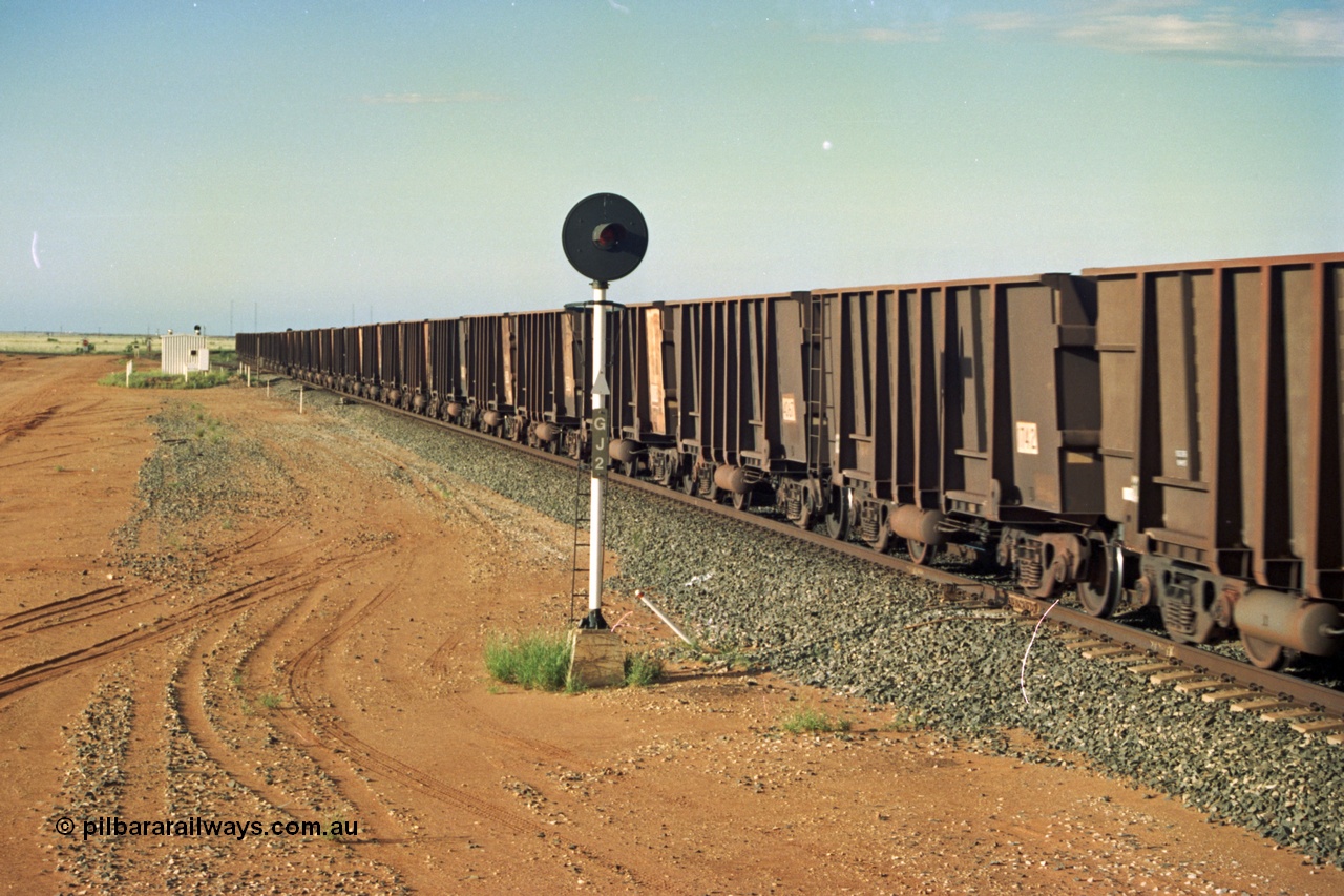 220-33
Goldsworthy Junction, an empty train rolls through the Junction on the Newman Mainline with mostly Comeng WA style built waggons and the odd Goninan one. This area is now fully duplicated.
