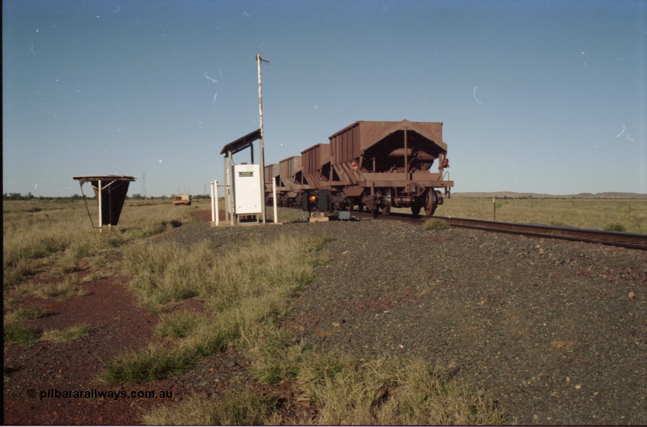 221-11
Hardie Siding, with the switch now set for the siding, the empty train is reversing out back onto the mainline, the ore cars are Tomlinson Steel built bottom discharge units. Note the end of train device are two flashing red lights, and no digitair.
