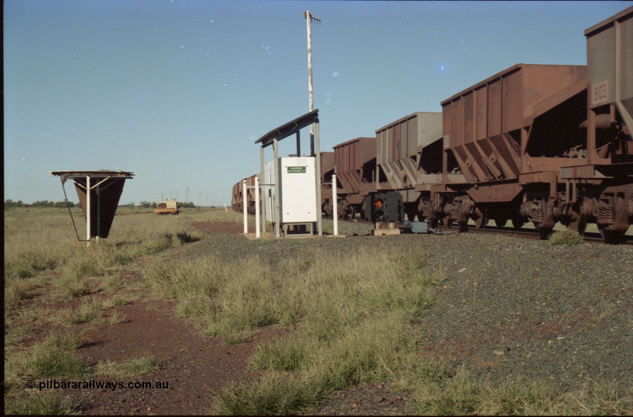 221-12
Hardie Siding, with the switch now set for the siding, the empty train is reversing out back onto the mainline, the ore cars are Tomlinson Steel built bottom discharge units.
