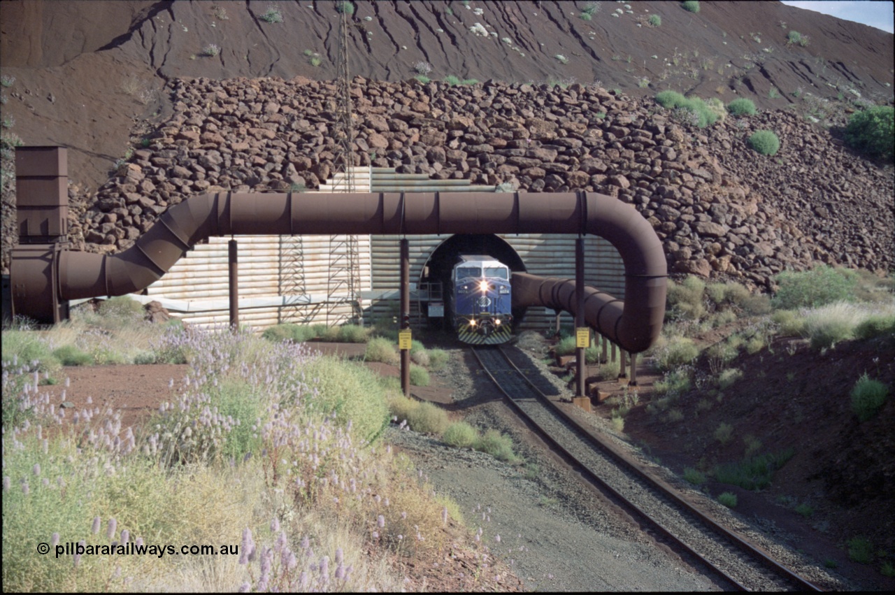 221-23
Yandi One mine loadout balloon loop, General Electric AC6000 class emerges from the loadout portal at 0.9 km/h as it leads a train through the loading vaults, the dust extraction ducting is also visible.
Keywords: GE;AC6000;51062-9;