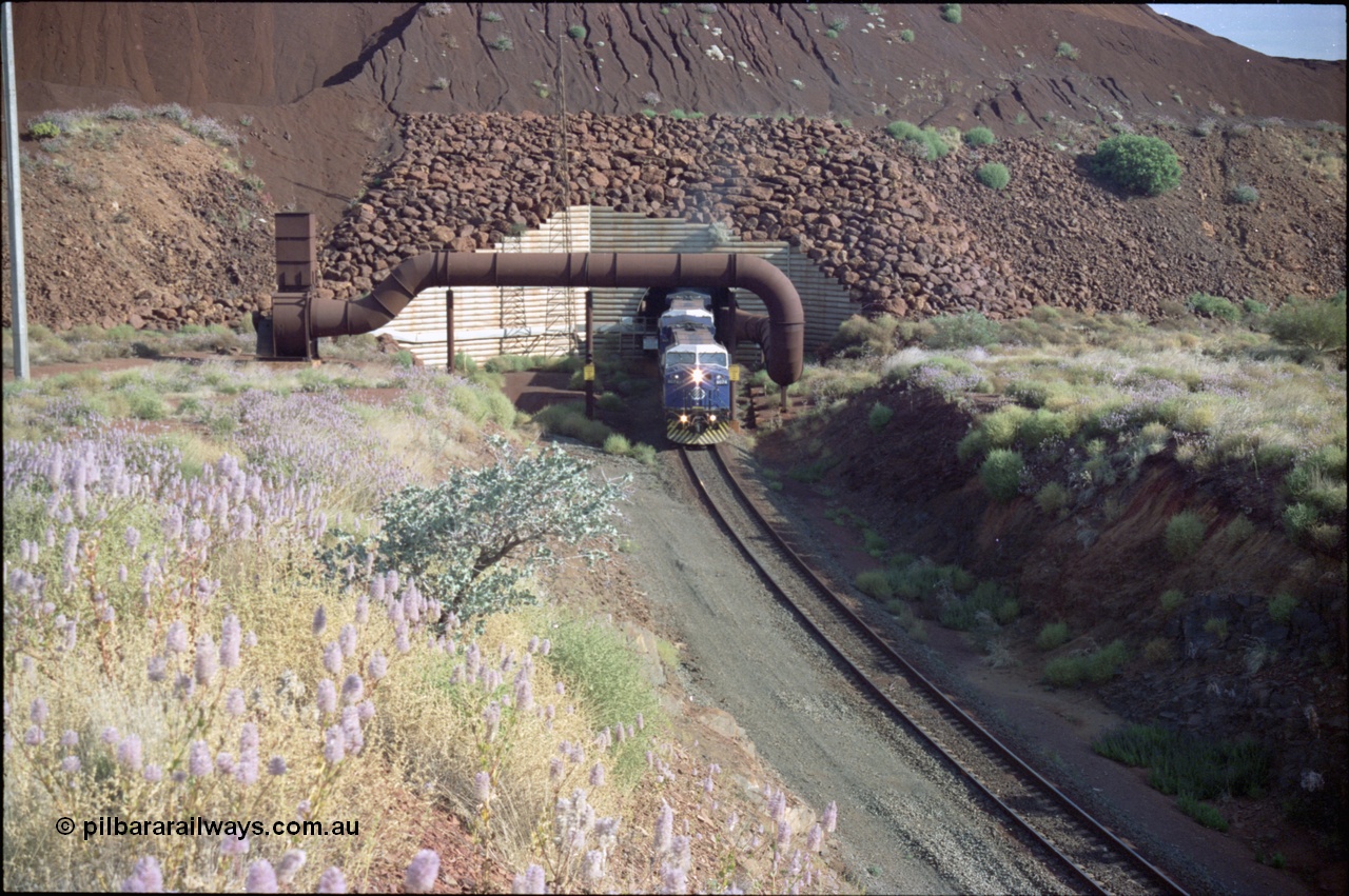 221-25
Yandi One mine loadout balloon loop, General Electric AC6000 class emerges from the loadout portal at 0.9 km/h as it leads a train through the loading vaults, the dust extraction ducting is also visible.
Keywords: GE;AC6000;51062-9;